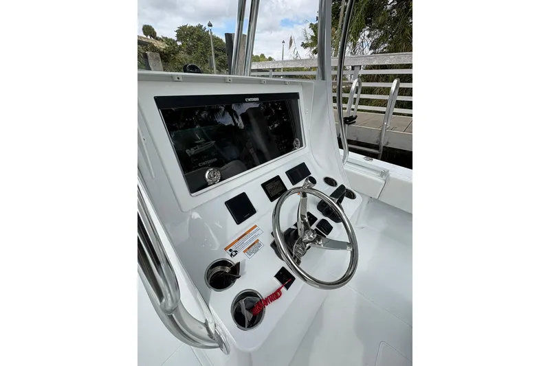Slide: The Image of 2026 Contender 32 ST boat console with steering wheel and control panel. - 19