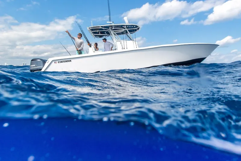 Slide: The Image of 2026 Contender 32 ST boat on ocean, people fishing under clear blue sky. - 6