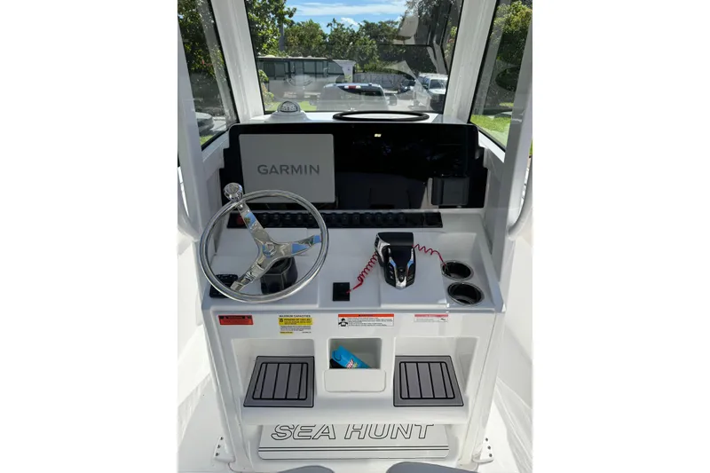 Slide: The Image of 2025 Sea Hunt Ultra 239 SE boat console with Garmin navigation system and steering wheel. - 14