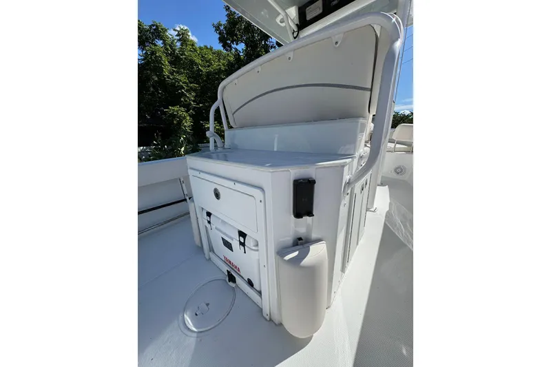 Slide: The Image of 2025 Sea Hunt Ultra 239 SE boat interior with storage and seating area. - 22