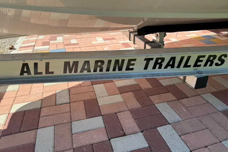 Slide: The Image of Trailer for 2025 Sea Hunt Ultra 239 SE on brick pavement. - 26