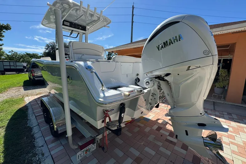 Slide: The Image of 2025 Sea Hunt Ultra 239 SE boat with Yamaha outboard engine on a trailer. - 4