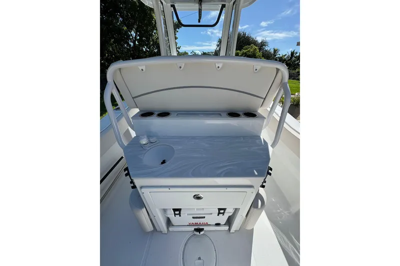 Slide: The Image of 2025 Sea Hunt Ultra 239 SE boat interior with console and storage. - 8