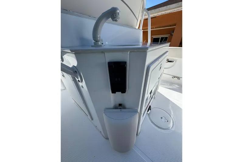 Slide: The Image of 2025 Sea Hunt Ultra 239 SE boat interior with storage compartments and faucet. - 9