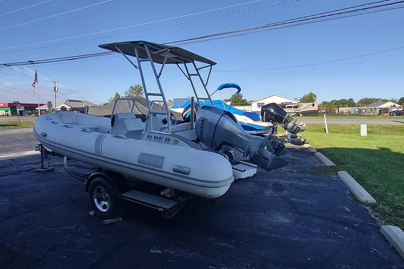 The Image of 2024 Valken 520 inflatable boat on trailer, parked outdoors under clear sky. - 0