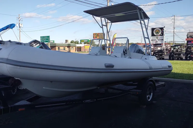 Slide: The Image of 2024 Valken 520 inflatable boat on trailer, parked outdoors under clear sky. - 11