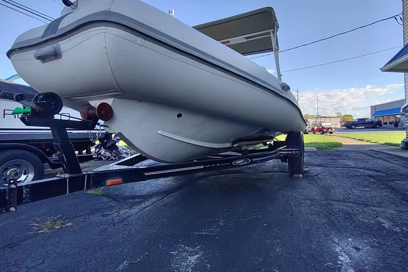 Slide: The Image of 2024 Valken 520 boat on trailer, parked outdoors on asphalt. - 13