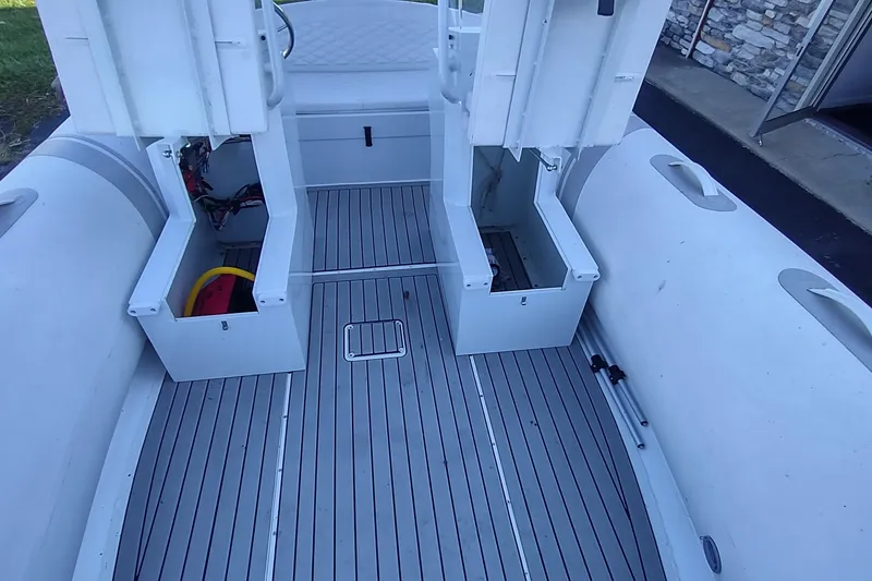 Slide: The Image of 2024 Valken 520 boat interior with open storage compartments and sleek gray flooring. - 5