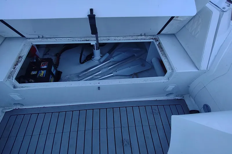 Slide: The Image of Open storage compartment on 2024 Valken 520 boat, showing battery and equipment. - 7
