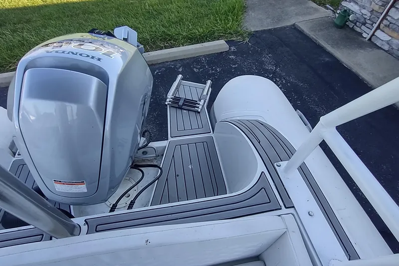 Slide: The Image of 2024 Valken 520 boat with Honda outboard motor and deck ladder. - 8