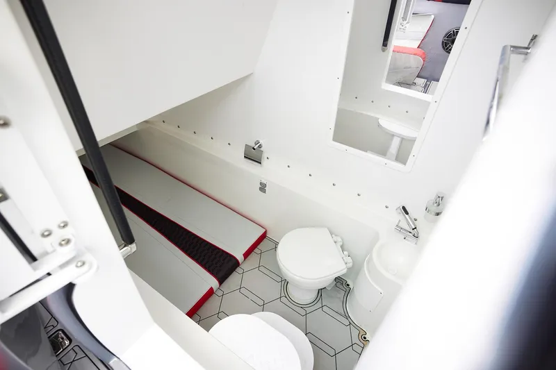 Slide: The Image of 2025 Midnight Express 37' Open boat interior with compact bathroom and sleeping area. - 16