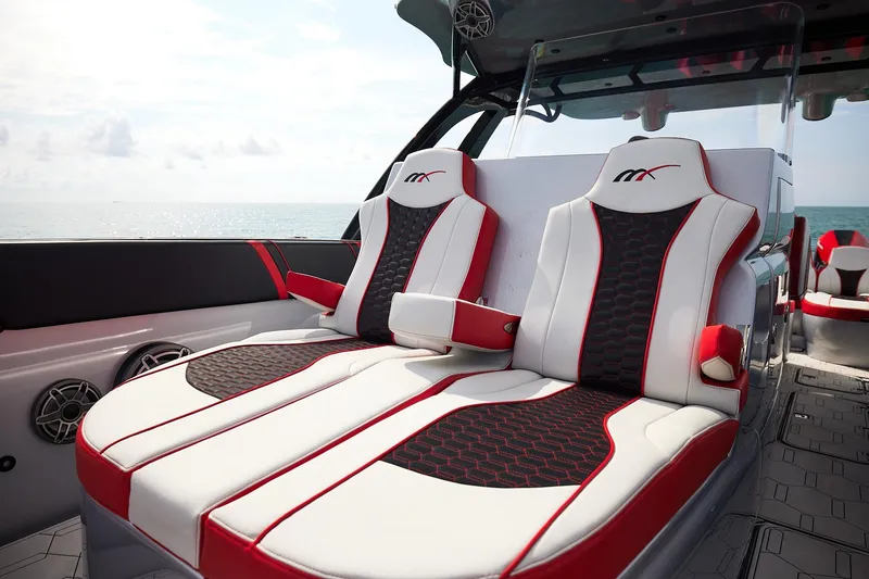 Slide: The Image of Luxurious seating on 2025 Midnight Express 37' Open boat, featuring sleek red and white design. - 8