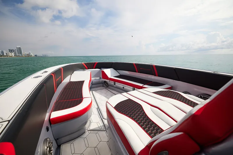 Slide: The Image of 2025 Midnight Express 37' Open boat interior with red and white seating, ocean view. - 9