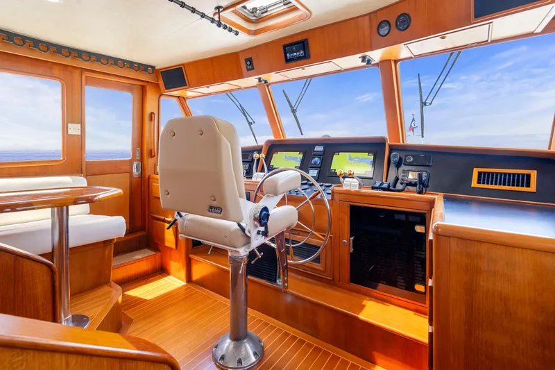Slide: The Image of Luxurious 1995 Fleming 55 yacht interior with helm, navigation screens, and seating area. - 19