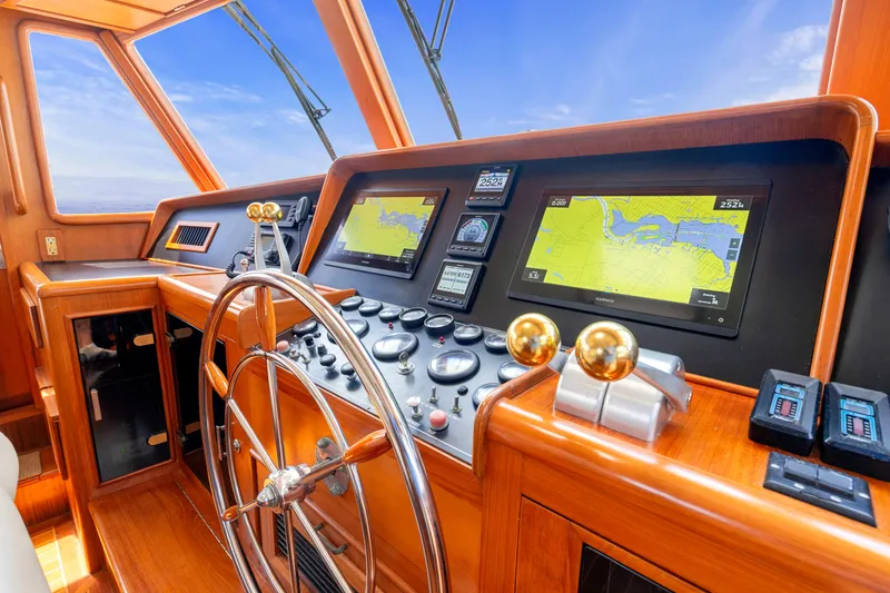Slide: The Image of Helm of 1995 Fleming 55 yacht with navigation screens and wooden steering wheel. - 20