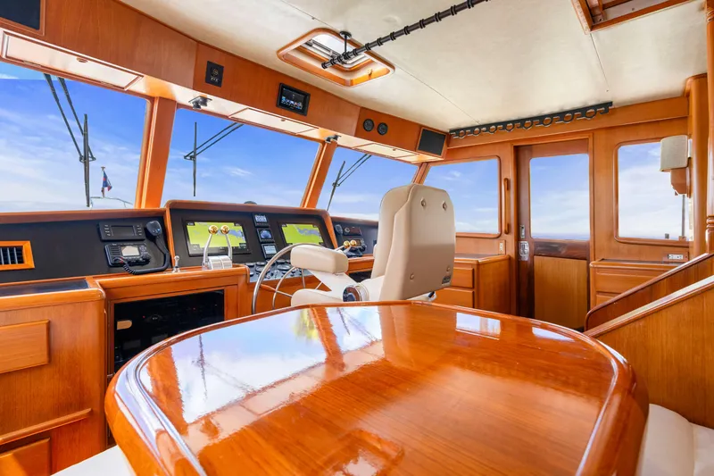 Slide: The Image of Luxurious 1995 Fleming 55 yacht interior with polished wood and modern navigation equipment. - 23