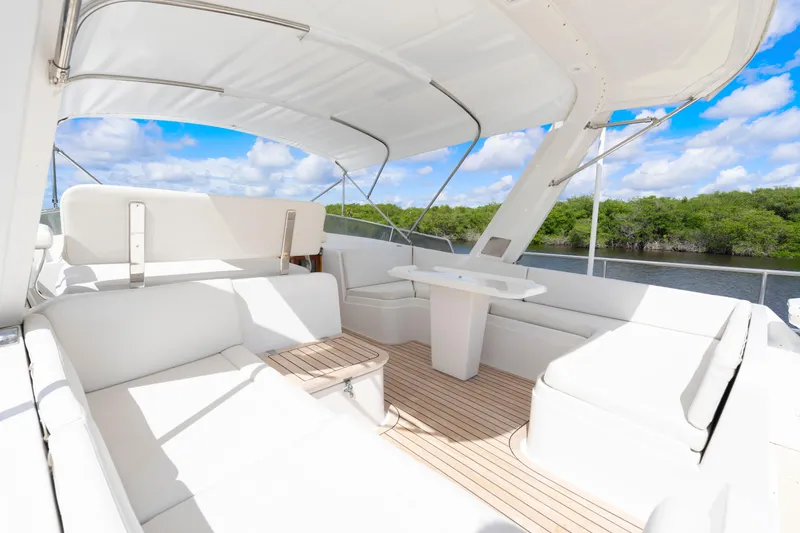 Slide: The Image of Luxurious 1995 Fleming 55 yacht with spacious white seating and scenic river view. - 30