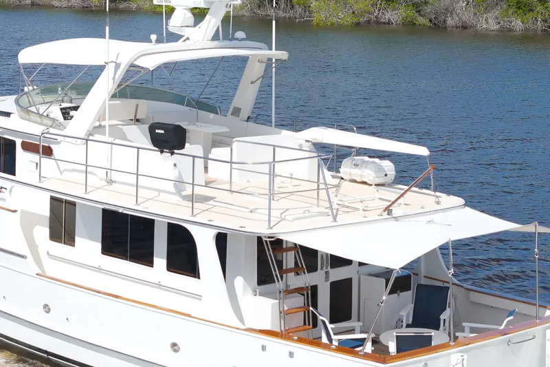 Slide: The Image of Luxury 1995 Fleming 55 yacht cruising on a serene river. - 33