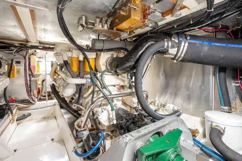 Slide: The Image of Engine room of a 1995 Fleming 55 yacht, showcasing complex machinery and piping. - 45