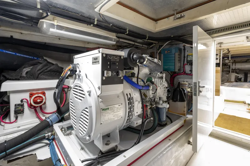 Slide: The Image of Engine room of a 1995 Fleming 55 yacht, featuring a Phasor generator. - 47