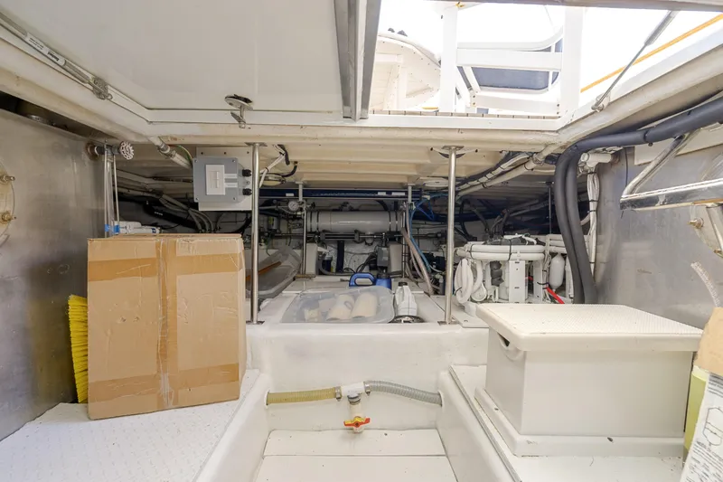 Slide: The Image of Engine room of a 1995 Fleming 55 yacht, featuring equipment and storage. - 48