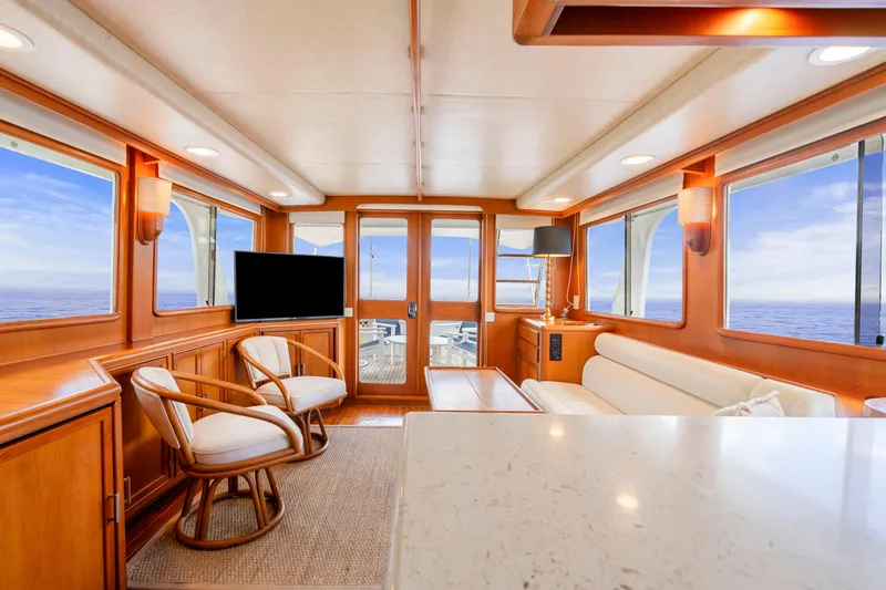 Slide: The Image of Luxurious interior of 1995 Fleming 55 yacht with ocean view, featuring elegant wood finishes. - 5