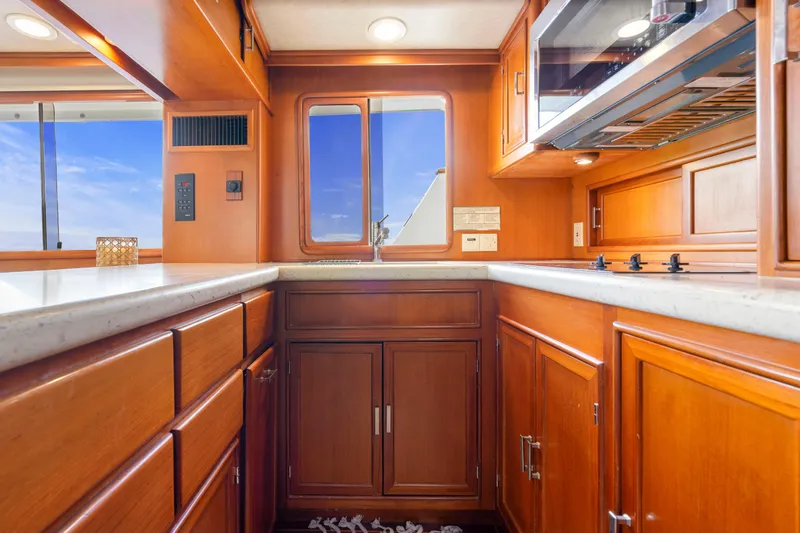 Slide: The Image of Luxurious 1995 Fleming 55 yacht kitchen with wooden cabinetry and modern appliances. - 7