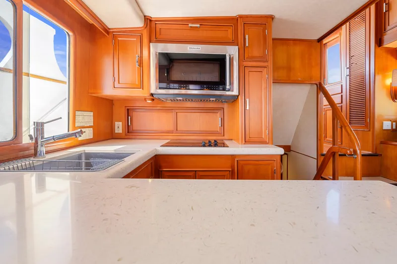 Slide: The Image of Luxurious kitchen interior of 1995 Fleming 55 yacht with wooden cabinetry and modern appliances. - 9