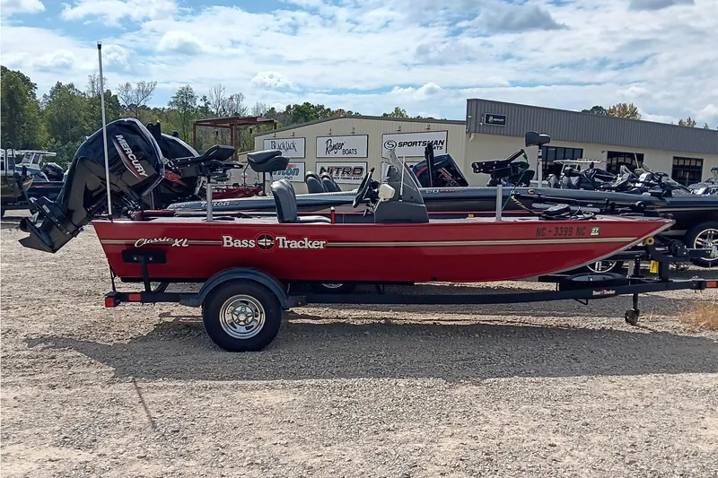 The Image of 2024 Tracker Bass Tracker Classic XL boat in red, parked outdoors on a trailer. - 0