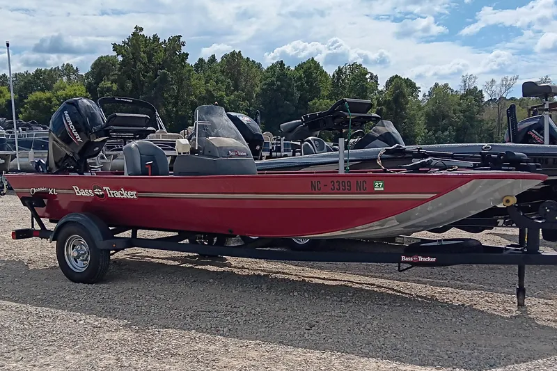 Slide: The Image of 2024 Tracker Bass Tracker Classic XL boat on trailer, parked outdoors. - 2