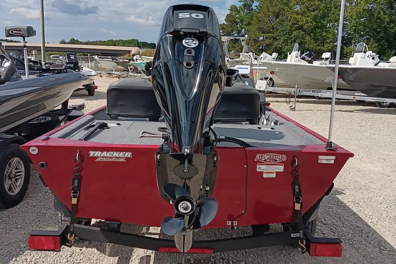 Slide: The Image of 2024 Tracker Bass Tracker Classic XL boat with outboard motor in a dealership lot. - 3