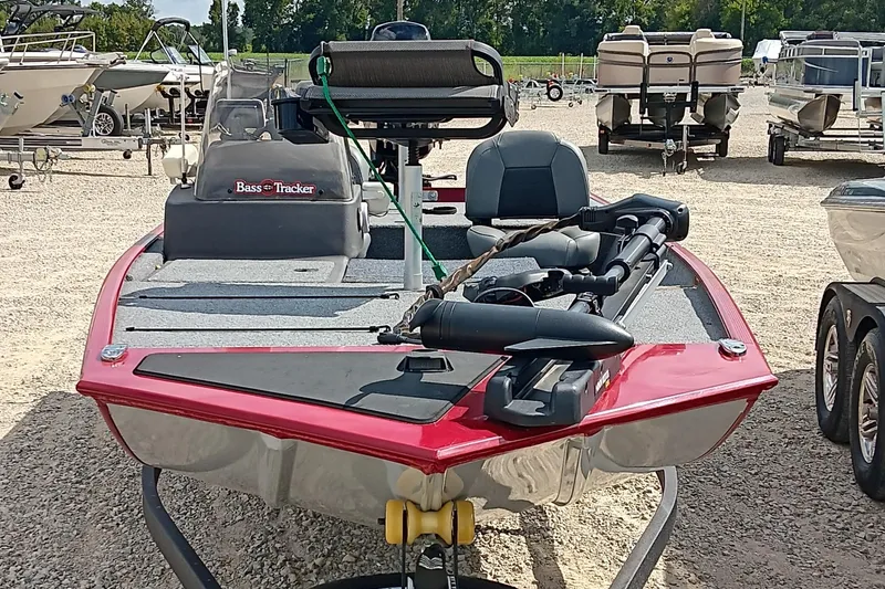 Slide: The Image of 2024 Tracker Bass Tracker Classic XL boat in a marina, featuring a red and gray design. - 4