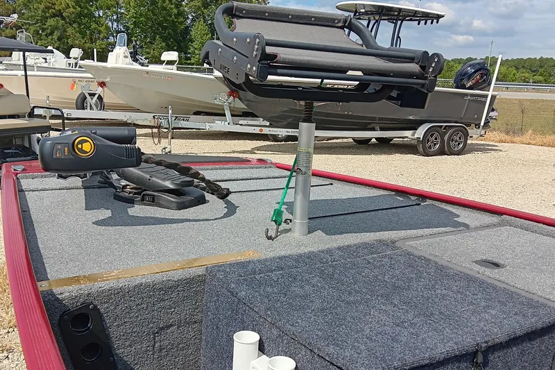 Slide: The Image of 2024 Tracker Bass Tracker Classic XL boat with fishing equipment on deck, parked on gravel. - 7