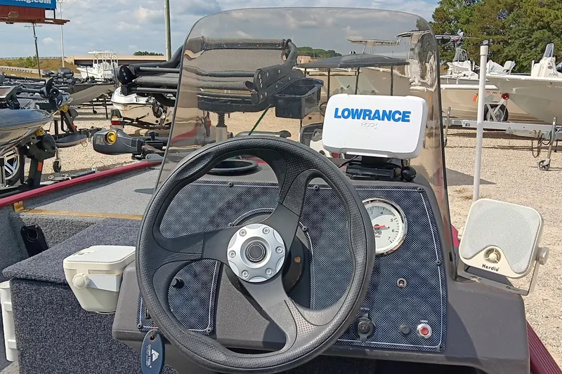 Slide: The Image of 2024 Tracker Bass Tracker Classic XL boat dashboard with steering wheel and Lowrance fish finder. - 9