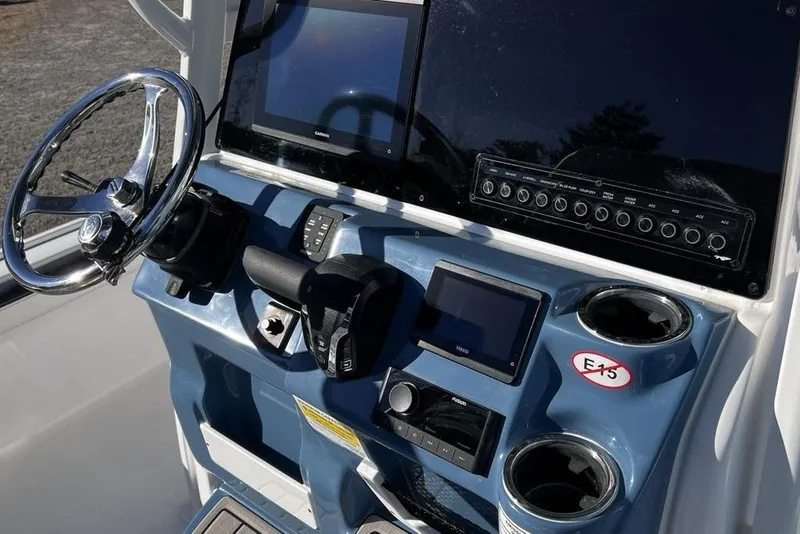 Slide: The Image of Control panel of 2026 Tidewater 2300 Carolina Bay boat with steering wheel and displays. - 11