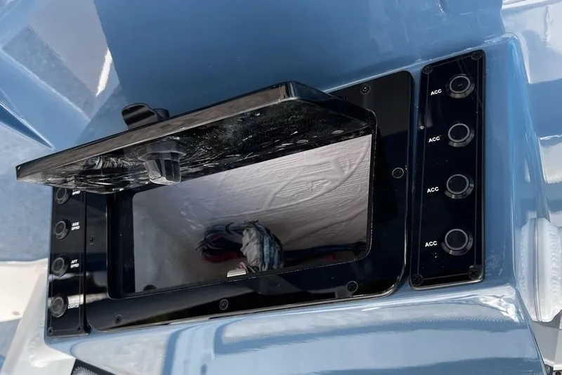 Slide: The Image of Open storage compartment on 2026 Tidewater 2300 Carolina Bay boat dashboard. - 15