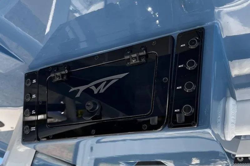 Slide: The Image of Control panel of 2026 Tidewater 2300 Carolina Bay boat with switches and logo. - 16