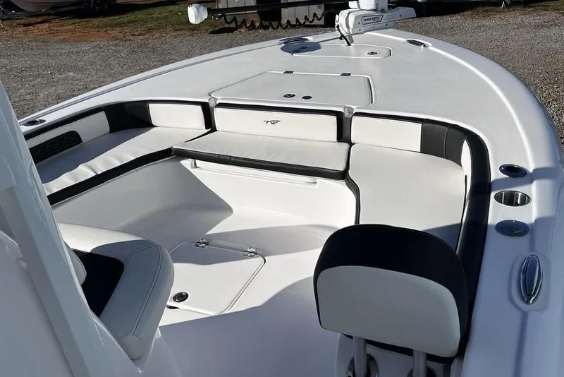 Slide: The Image of 2026 Tidewater 2300 Carolina Bay boat interior with cushioned seating and storage compartments. - 19