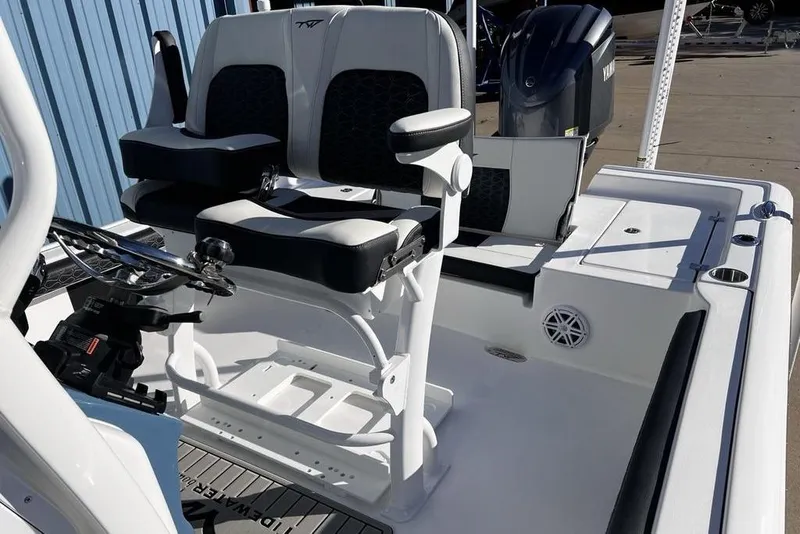 Slide: The Image of 2026 Tidewater 2300 Carolina Bay boat interior with dual seating and steering console. - 32