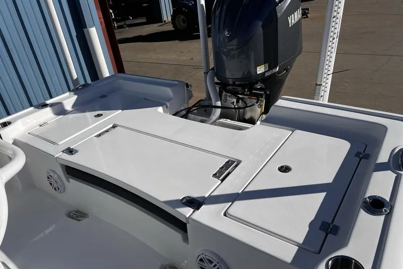 Slide: The Image of 2026 Tidewater 2300 Carolina Bay boat with Yamaha engine, docked outdoors. - 33