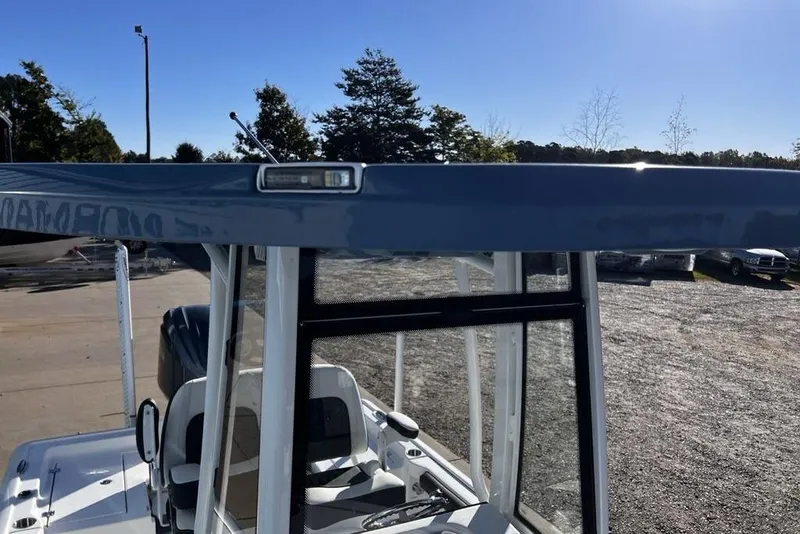 Slide: The Image of 2026 Tidewater 2300 Carolina Bay boat with T-top, parked outdoors under clear sky. - 36
