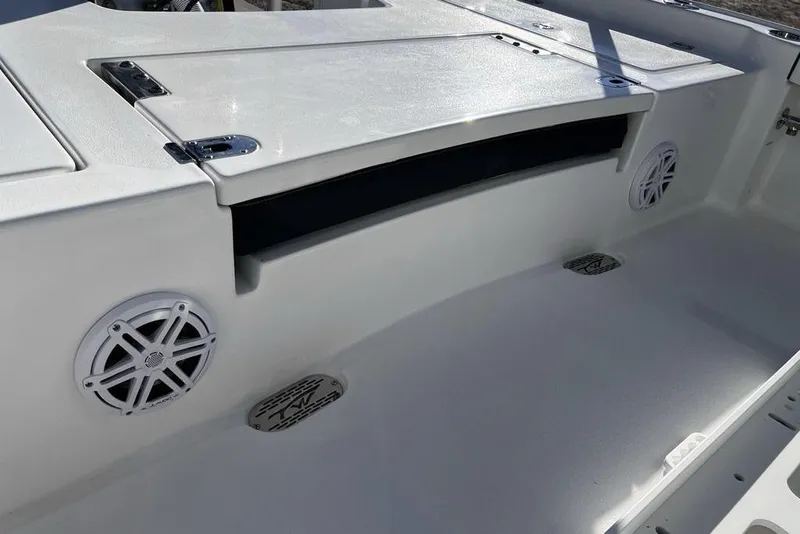 Slide: The Image of 2026 Tidewater 2300 Carolina Bay boat interior with speakers and storage compartment. - 40