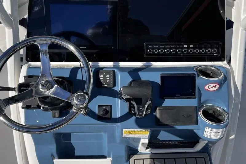 Slide: The Image of Control panel of 2026 Tidewater 2300 Carolina Bay boat with steering wheel and electronics. - 7