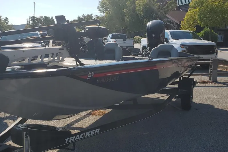 The Image of 2018 Tracker Pro Team 195 TXW 40th Anniversary Edition boat on trailer in parking lot. - 0