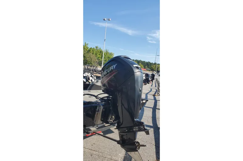 Slide: The Image of 2018 Tracker Pro Team 195 TXW boat with Mercury outboard motor in parking lot. - 7