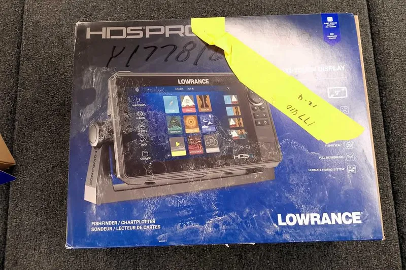 Slide: The Image of Box of Lowrance HDS Pro fishfinder/chartplotter on carpet, featuring advanced navigation display. - 19
