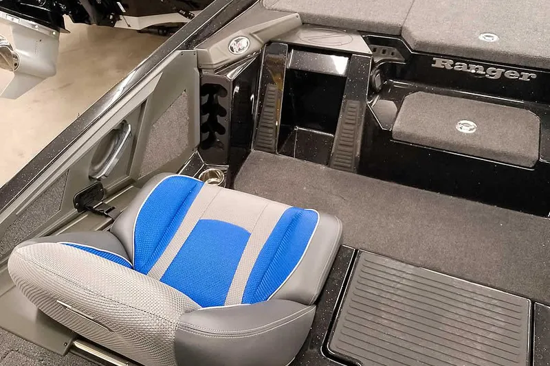 Slide: The Image of 2025 Ranger Z518 Ranger Cup boat interior with blue and gray seating. - 27