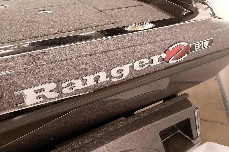 Slide: The Image of 2025 Ranger Z518 Ranger Cup Equipped boat, close-up of logo and textured surface. - 4