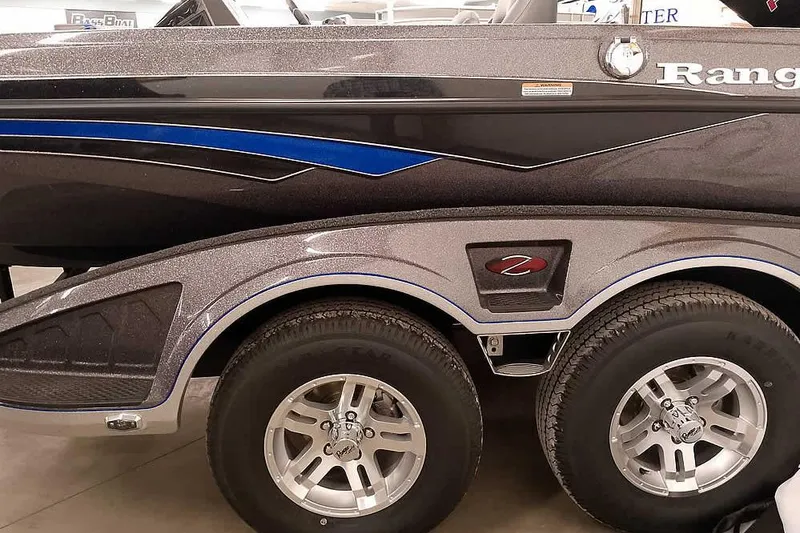 Slide: The Image of 2025 Ranger Z518 Ranger Cup Equipped boat with dual axle trailer, close-up view. - 9