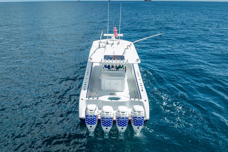 Slide: The Image of 2023 Yellowfin 39 Offshore boat with four engines on open ocean. - 13